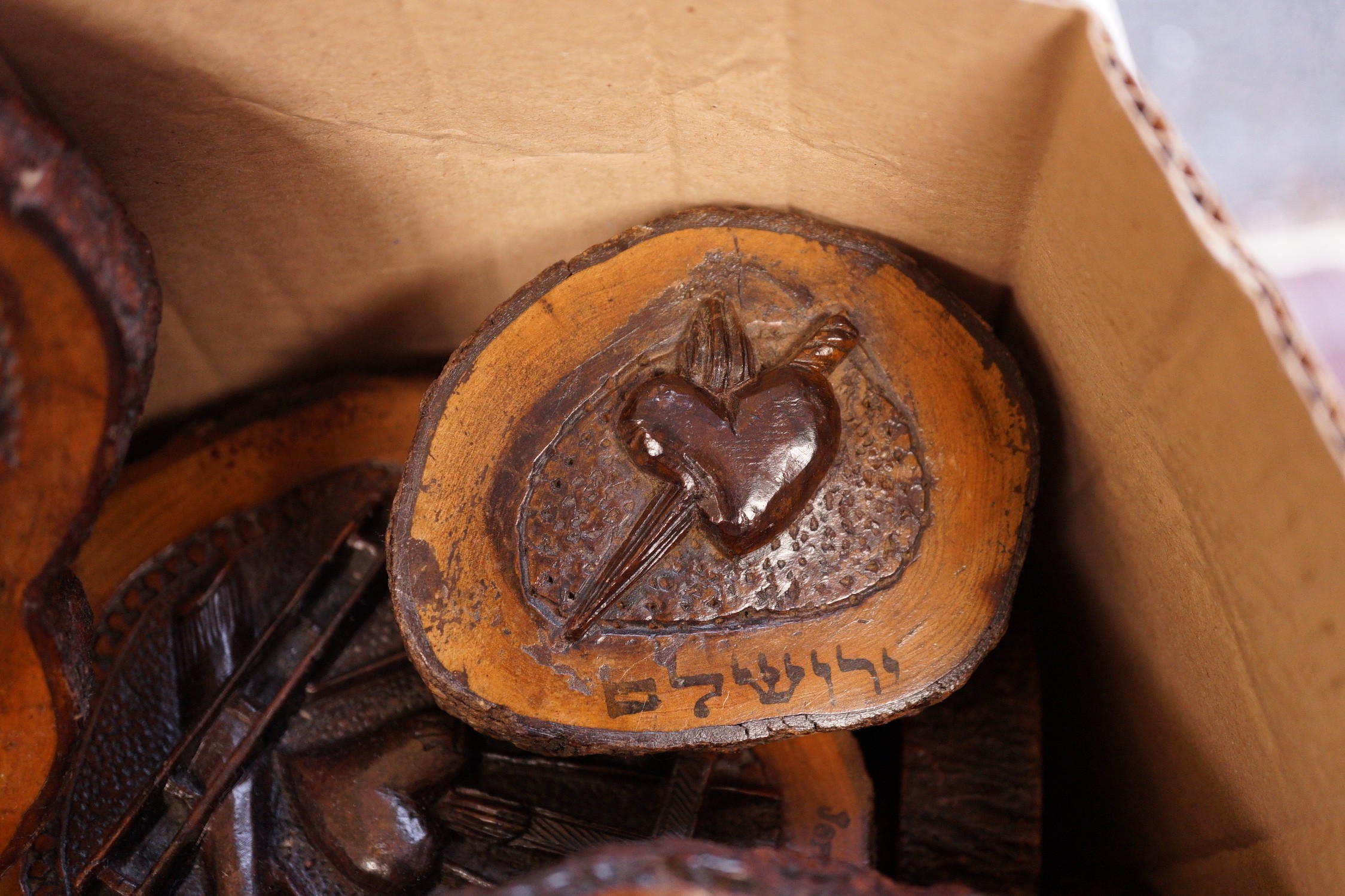 A collection of Jerusalem carved oyster olive wood roundels, religious and other symbolism